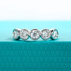 The Arch Band — 4mm moissanite bezel half eternity ring, front view — Aurora Moissanite