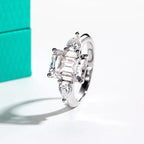 The Amara Ring worn — 4ct emerald 0.5ct pear moissanite two-stone, 18K gold — Aurora Moissanite