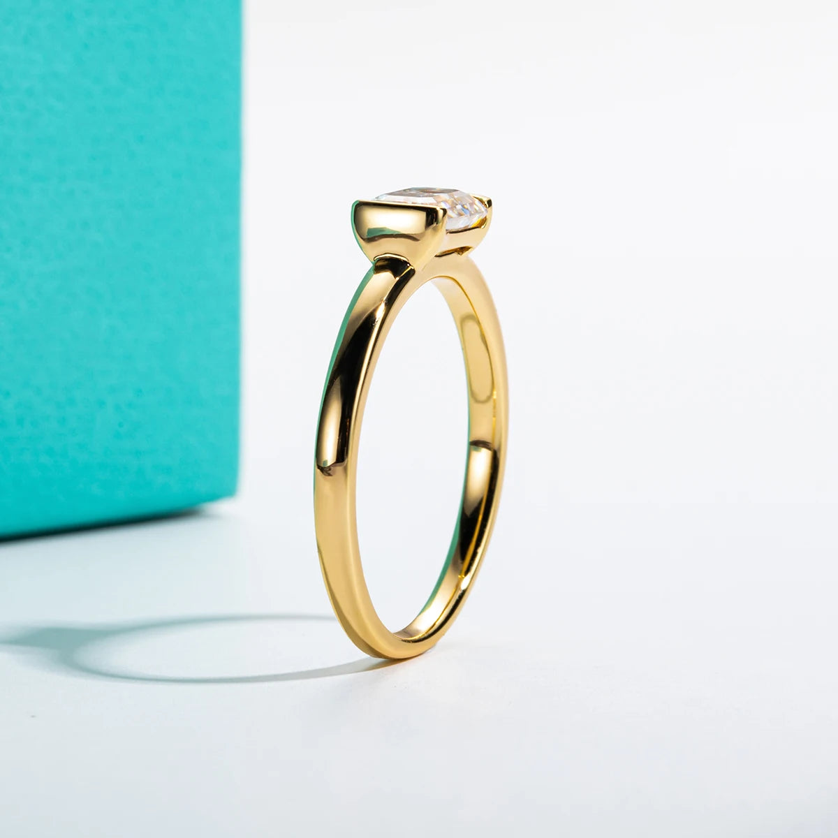 The Gill Ring lifestyle — 1ct emerald moissanite yellow gold worn on finger — Aurora Moissanite