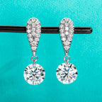 The Glow Earrings — 6cttw moissanite drops, front view, 18K gold — Aurora Moissanite