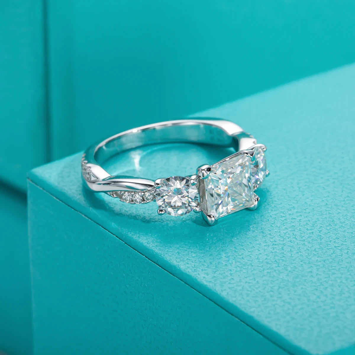 The Tove Ring lifestyle — princess three-stone moissanite ring worn on finger — Aurora Moissanite