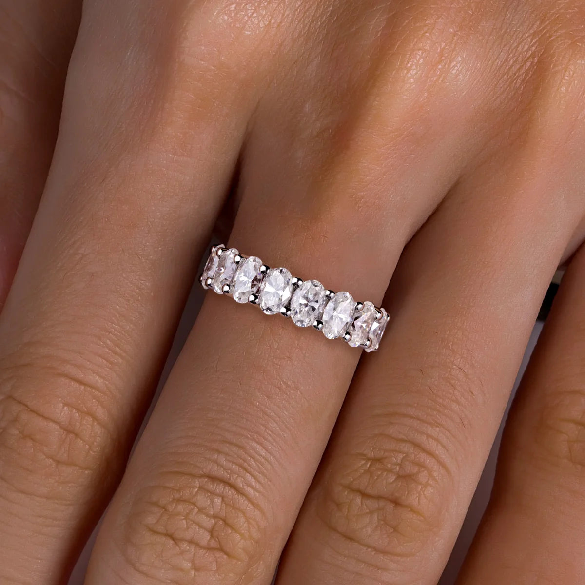 Oval cut moissanite eternity band top view, elongated stones across band — Aurora Moissanite