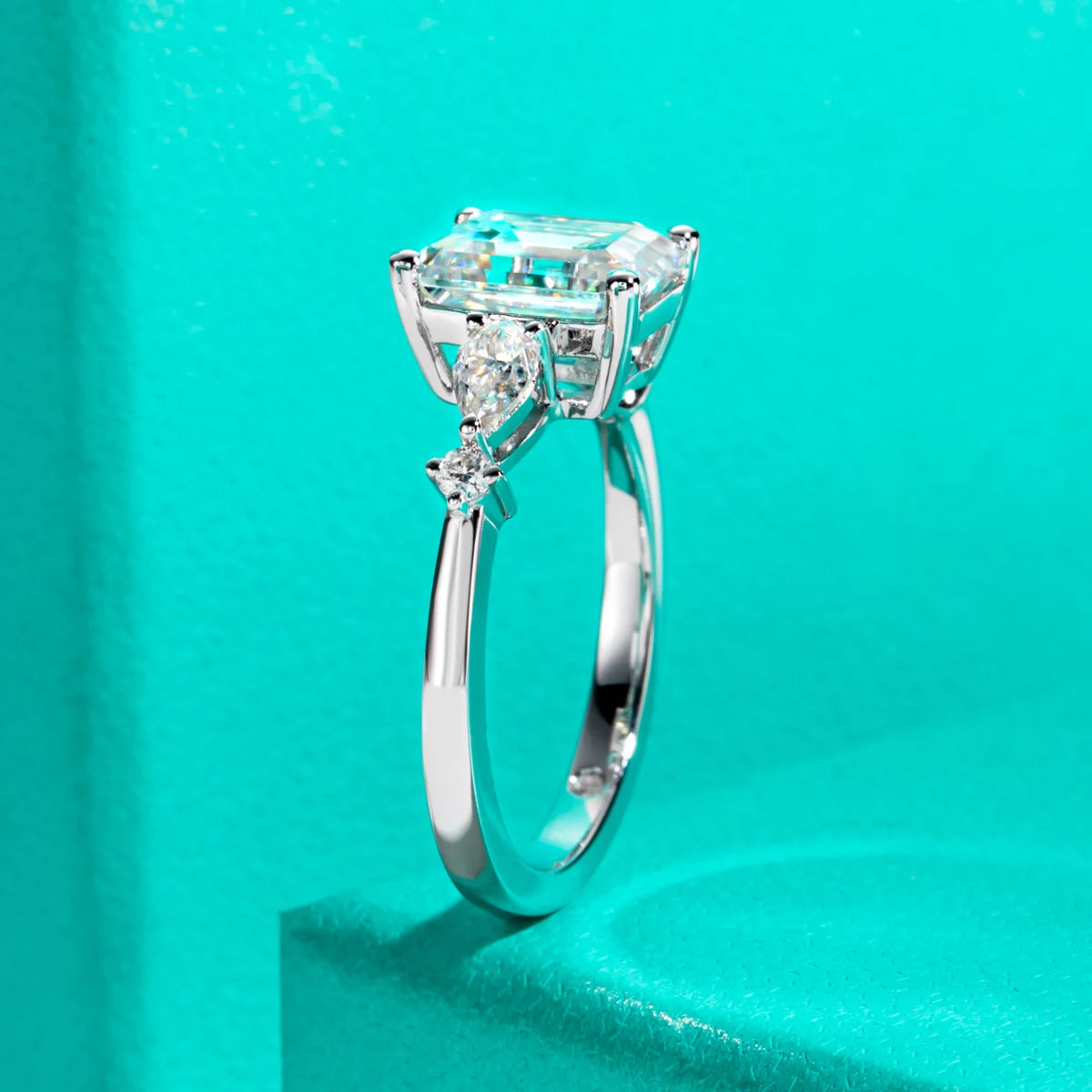 Emerald cut moissanite 3ct with pear accent 0.3ct D color VVS1, two-stone detail — Aurora Moissanite