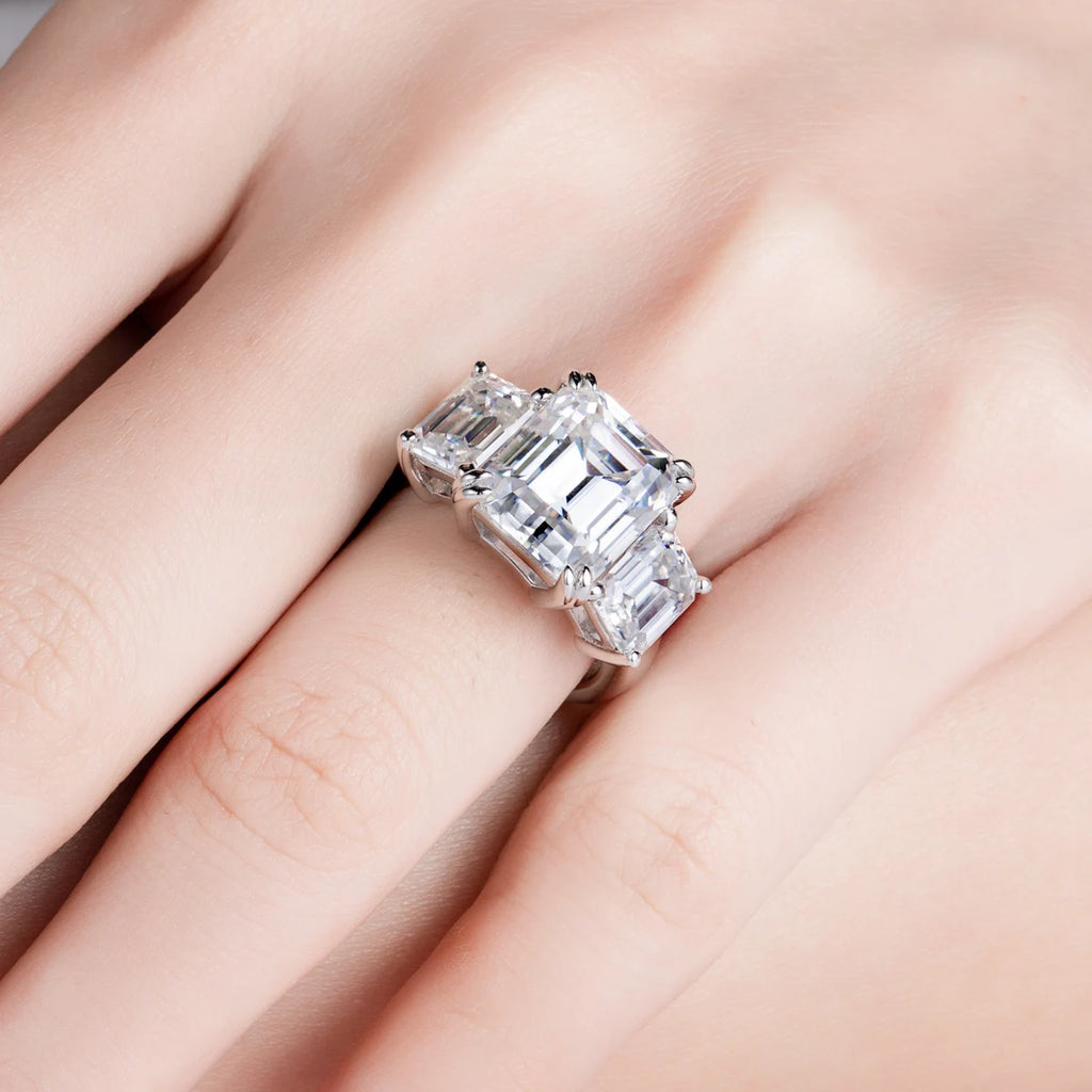 Emerald moissanite 3-stone ring top view, hall-of-mirrors step-cut pattern — Aurora Moissanite