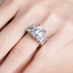 Emerald moissanite 3-stone ring top view, hall-of-mirrors step-cut pattern — Aurora Moissanite