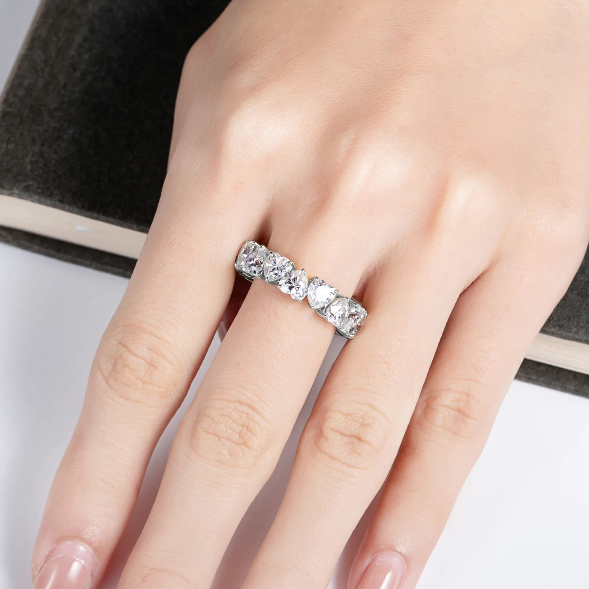 Heart cut moissanite eternity ring close-up, point-down orientation visible — Aurora Moissanite