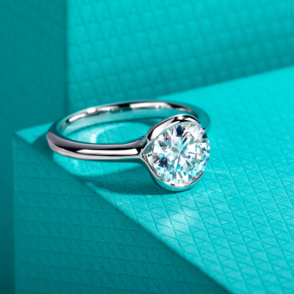 Round moissanite 2ct D color VVS1, partial bezel setting detail — Aurora Moissanite