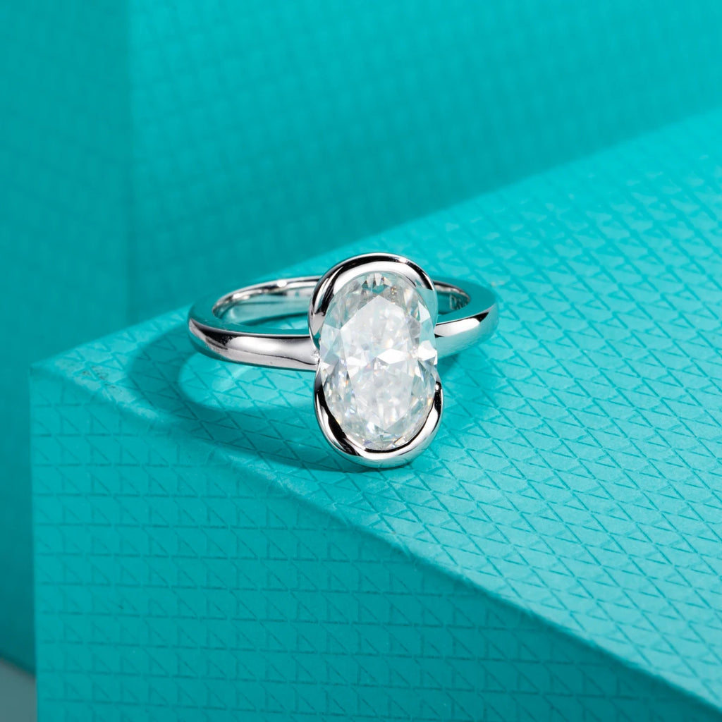 The Caer Ring — 3ct oval moissanite half-bezel, front view — Aurora Moissanite