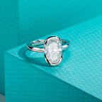 The Caer Ring — 3ct oval moissanite half-bezel, front view — Aurora Moissanite