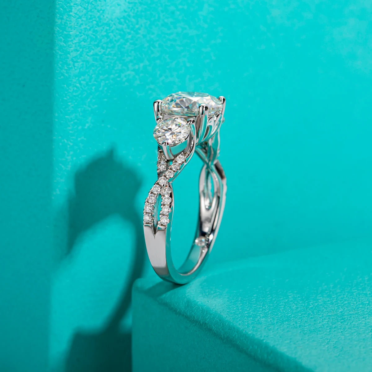 Three-stone moissanite 4.25cttw D color VVS1, infinity band detail — Aurora Moissanite