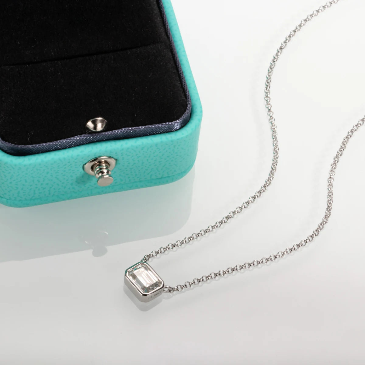 Emerald cut moissanite pendant, 18K white gold plated, top view showing step facets — Aurora Moissanite
