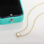 The Step Pendant worn — emerald cut moissanite pendant on neck, sterling silver — Aurora Moissanite