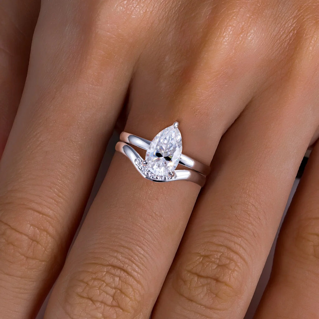 Pear moissanite engagement ring and wedding band set, top view — Aurora Moissanite