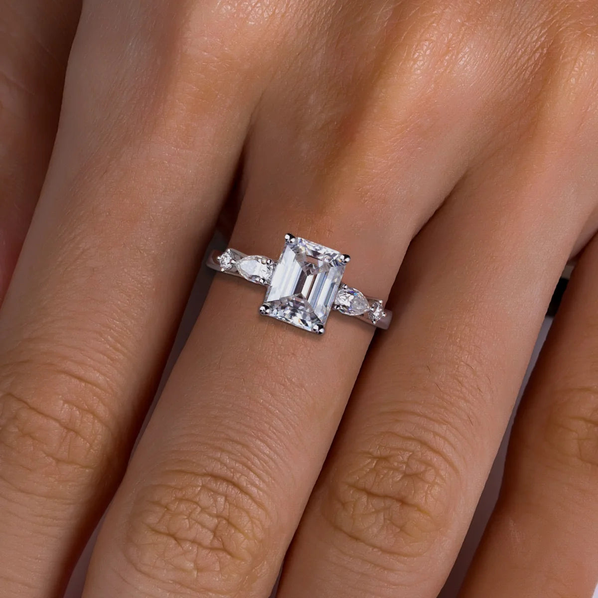The Vale Ring lifestyle — emerald pear moissanite two-stone ring worn on finger — Aurora Moissanite