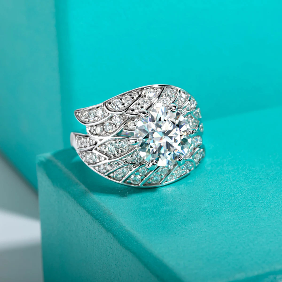 Moissanite angel wing ring 4cttw D color VVS1, wing setting detail — Aurora Moissanite