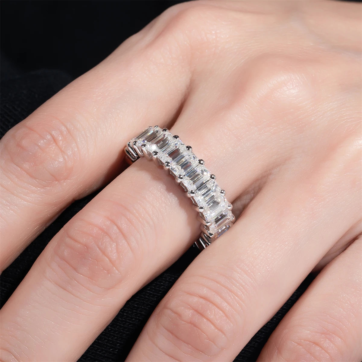 Emerald cut moissanite eternity ring top view, hall-of-mirrors step facets — Aurora Moissanite