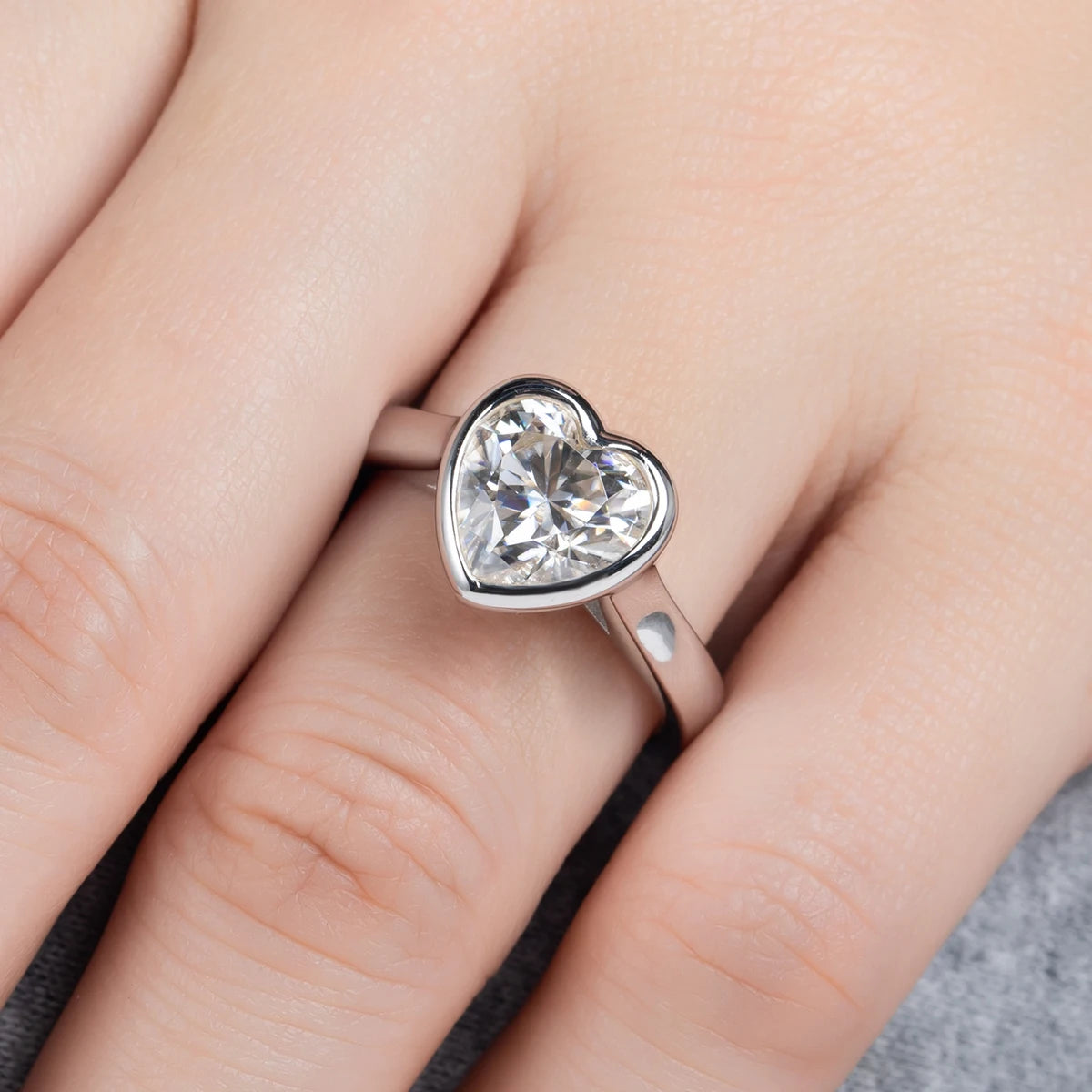 Heart moissanite bezel ring top view, custom bezel framing full heart outline — Aurora Moissanite