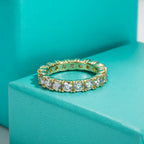 Moissanite eternity band 3.5mm D color VVS1, yellow gold, prong setting detail — Aurora Moissanite