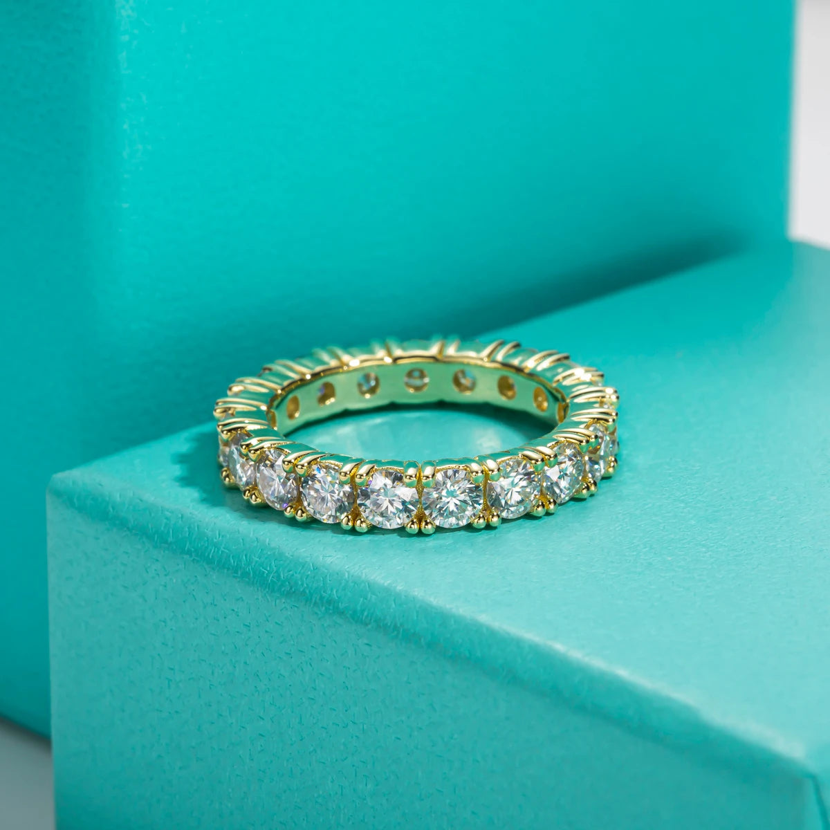 Moissanite eternity band 3.5mm D color VVS1, yellow gold, prong setting detail — Aurora Moissanite