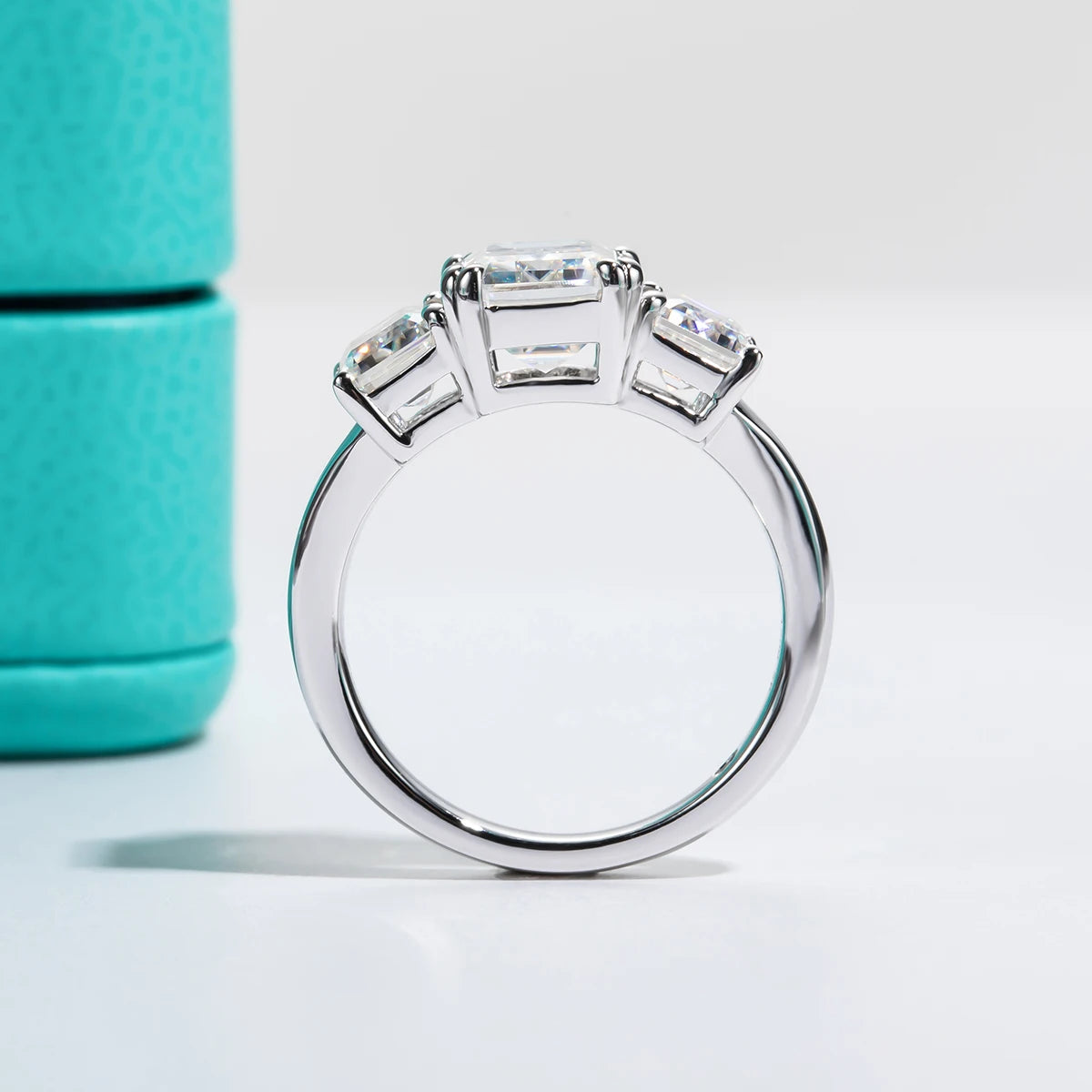 The Alva Ring lifestyle — 5cttw emerald three-stone moissanite worn on finger — Aurora Moissanite