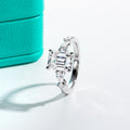 The Vale Ring worn — 3ct emerald 0.3ct pear moissanite two-stone, 18K gold — Aurora Moissanite