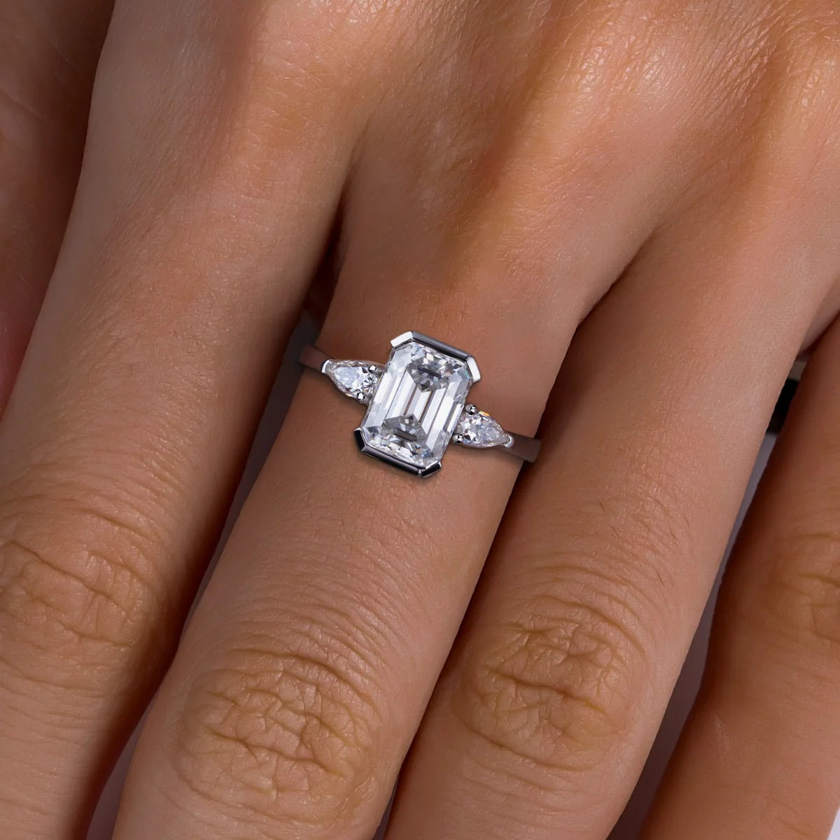 The Deia Ring lifestyle — emerald pear moissanite channel setting worn on finger — Aurora Moissanite