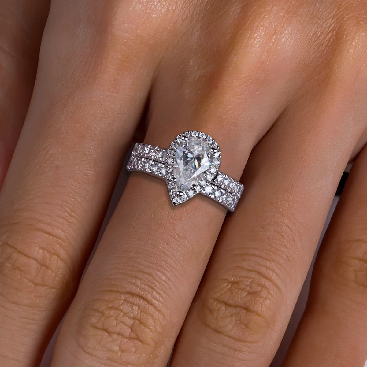 The Oria Ring lifestyle — 3ct pear halo moissanite bridal set worn on finger — Aurora Moissanite