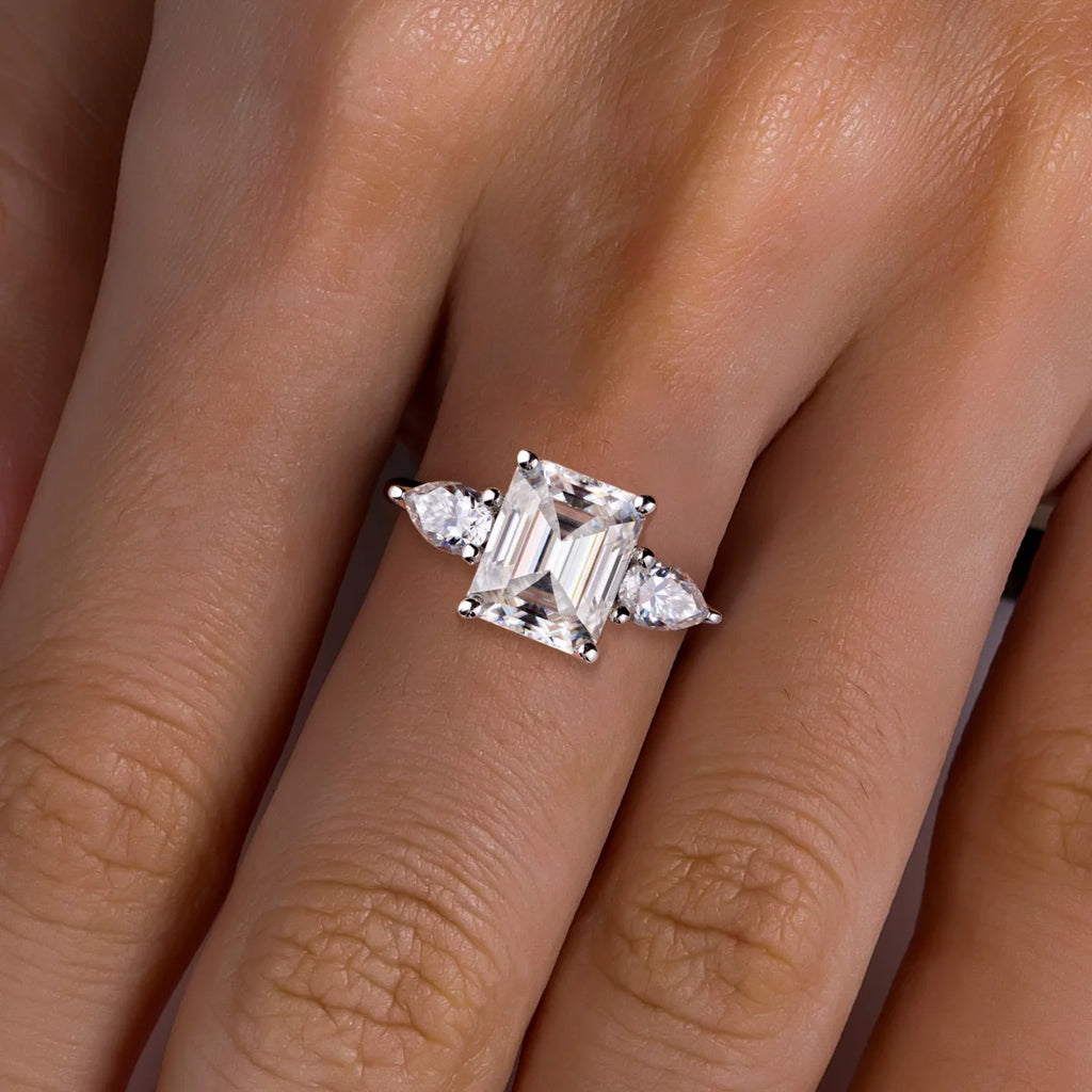 The Amara Ring lifestyle — 4ct emerald pear moissanite ring worn on finger — Aurora Moissanite