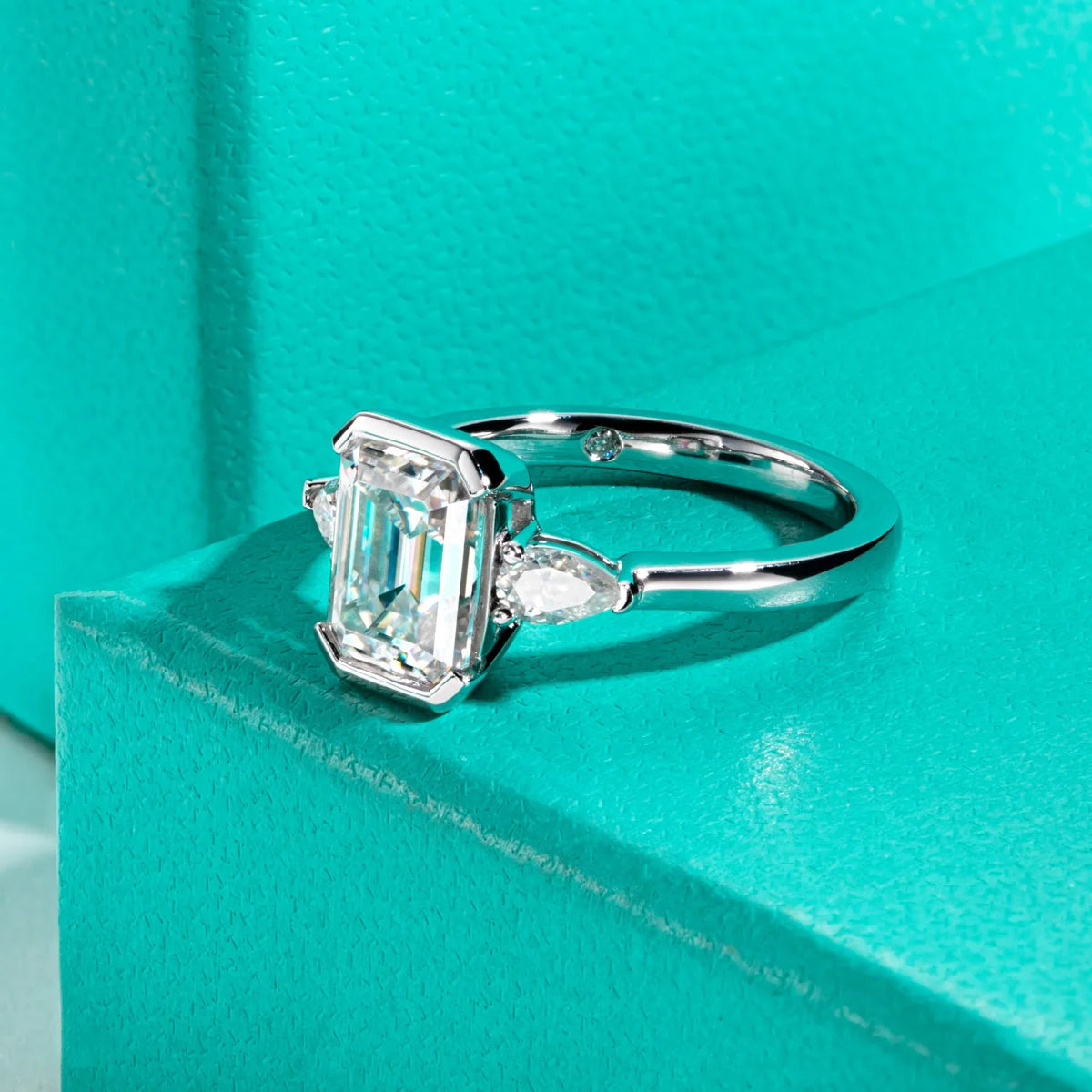 Emerald pear moissanite 3.6cttw channel setting D color VVS1, flush metal rails — Aurora Moissanite