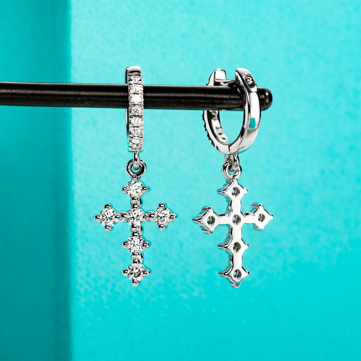 The Kael Earrings — moissanite cross huggie hoops, front view — Aurora Moissanite