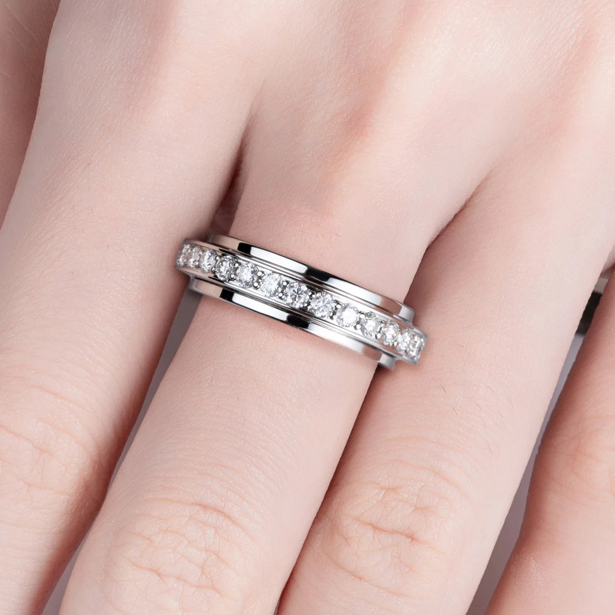 Moissanite spinner band top view showing full eternity stones on outer ring — Aurora Moissanite